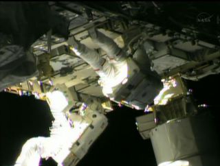 NASA astronauts Chris Cassidy (top) and Tom Marshburn work outside the International Space Station after replacing an ammonia coolant pump on May 11, 2013.