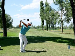 A player taking a tee shot at the Italian Open 2024