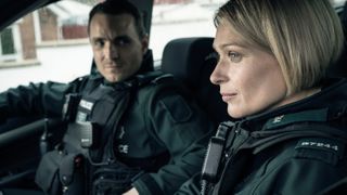 Grace (Sian Brooke) and Stevie (Martin McCann) in police gear in Blue Lights