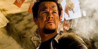 Mark Wahlberg staring in front of a Transformer