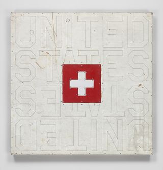 View of United States, 2018, by Tom Sachs - wall art with the wording 'UNITED STATES' in the background and an image of the red and white Swiss flag in the centre
