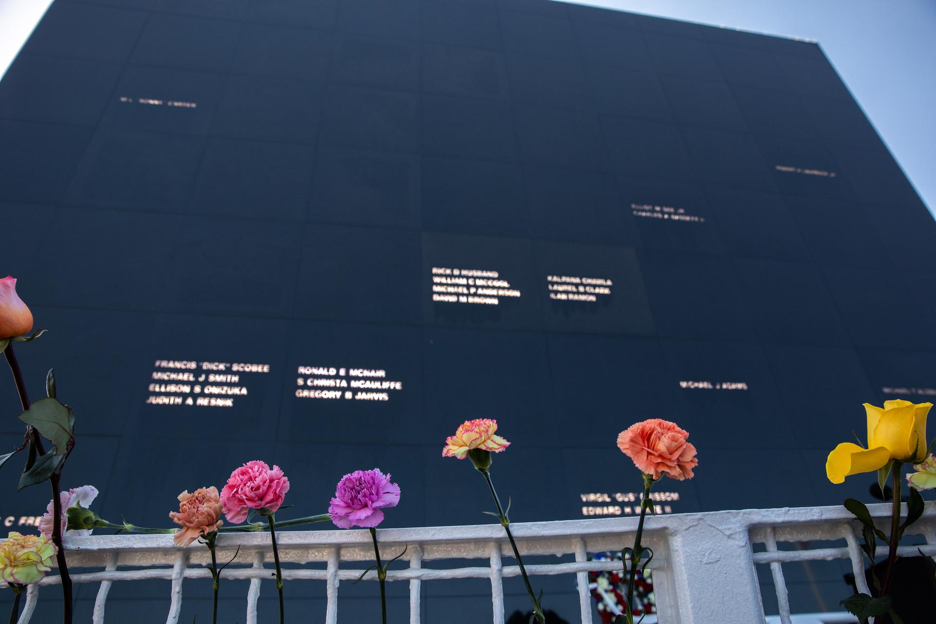 Flowers placed before the Space Mirror Memorial mark NASA’s Day of Remembrance at the Kennedy Space Center Visitor Complex, Jan. 28, 2021. The mirror was dedicated in 1991 to honor all astronauts who lost their lives on missions or during training.