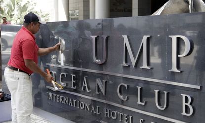 A worker removes the "Trump" name from a hotel sign in Panama.