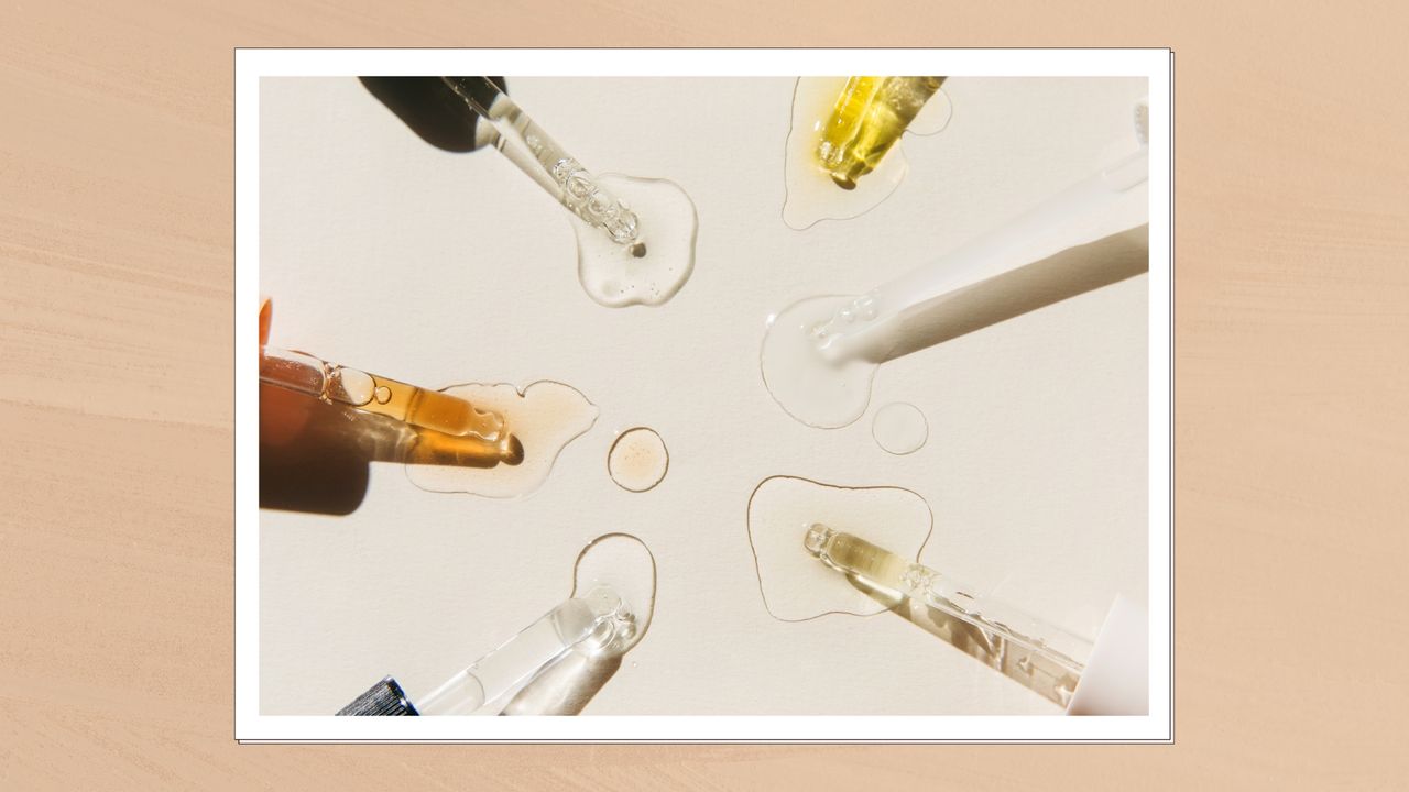 A close up of an array of different coloured skincare serums with glass pipettes to demonstrate chemical exfoliants, on a cream backdrop and in a beige template