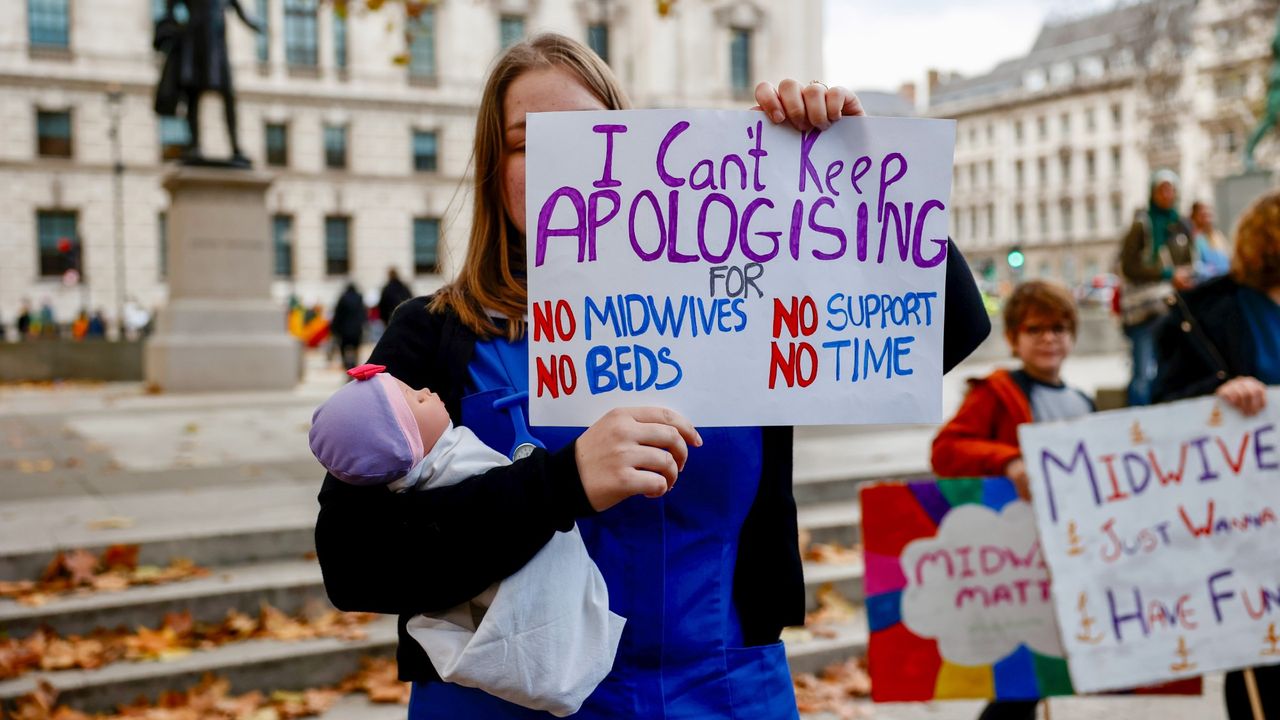 A midwife holds a placard during a demonstration in London in 2021 to draw attention to under-staffing and under-resourcing in NHS maternity services