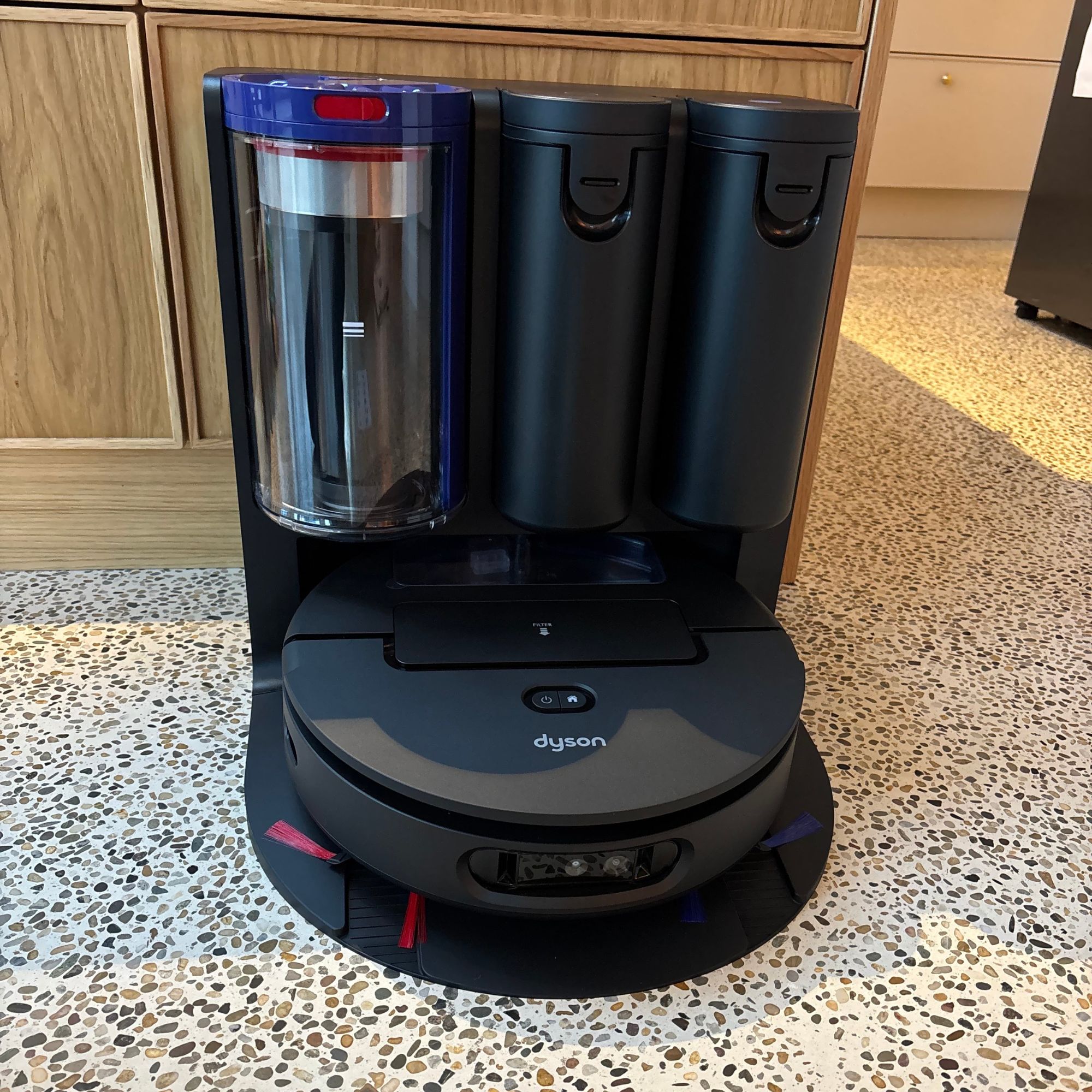 Dyson Spot+Scrub robot vacuum sitting on a kitchen floor
