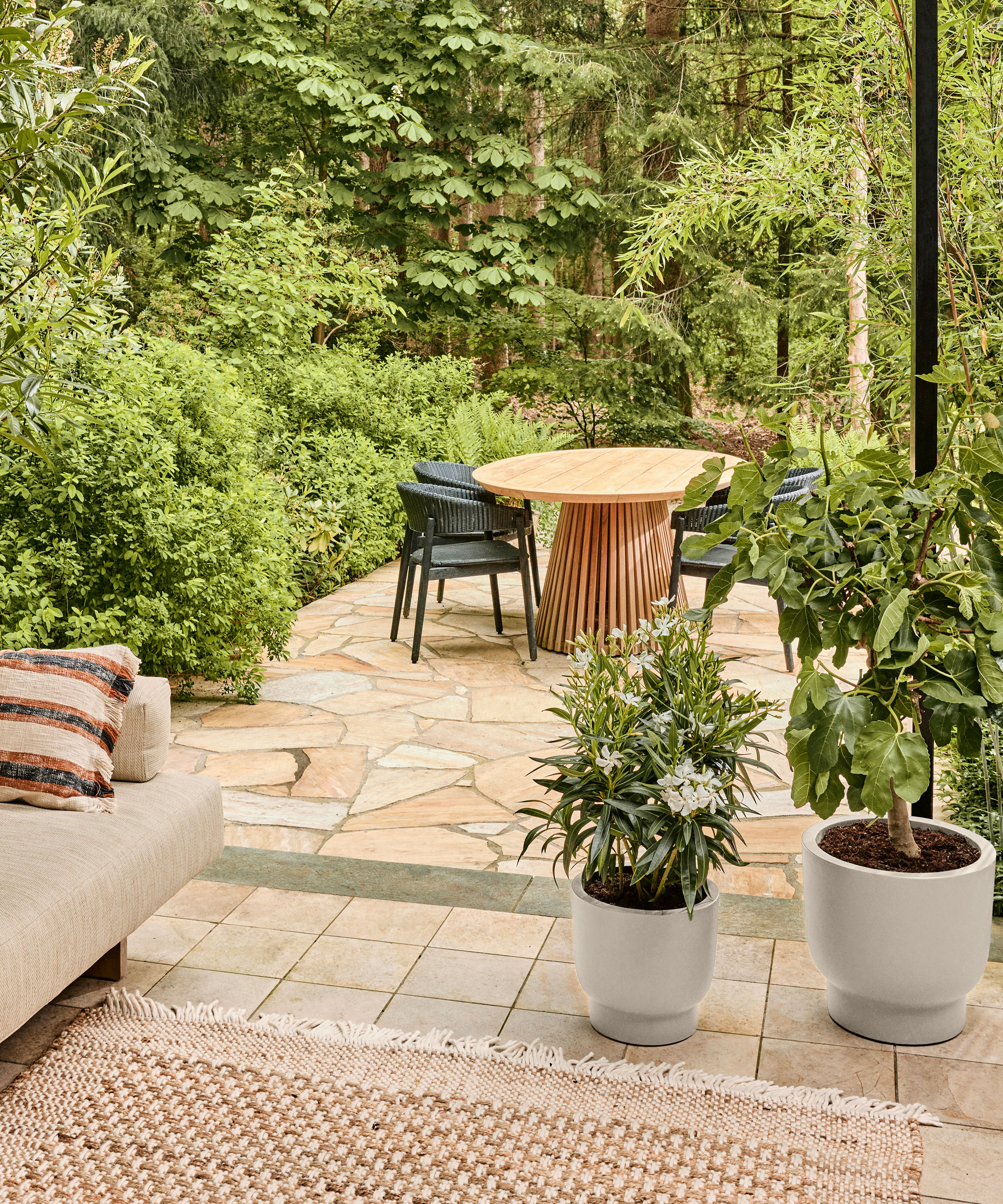 crazy paving patio with plants and garden furniture