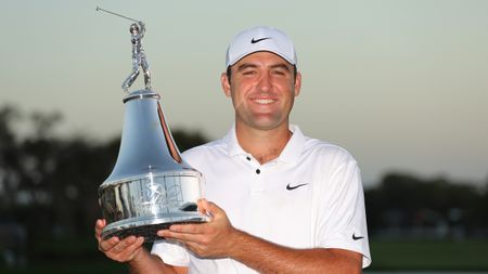 Scottie Scheffler holds aloft the trophy after winning the 2022 Arnold Palmer Invitational