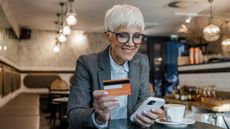 A woman uses her credit card rewards at a restaurant.