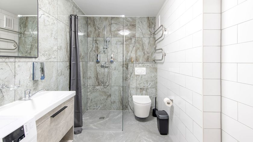 Face on image of mainly white contemporary bathroom with a focus on shower screen