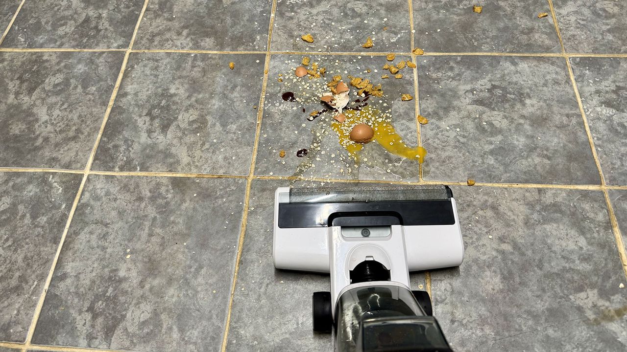 Gtech Orca hard floor cleaner approaching a food spillage including eggs and oats