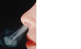 a person blowing smoke out of their nose