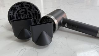 Revamp Tri-Care hair dryer placed alongside its diffuser and concentrator nozzles