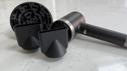 Revamp Tri-Care hair dryer placed alongside its diffuser and concentrator nozzles