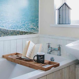 bathroom with wooden tray and cup of tea