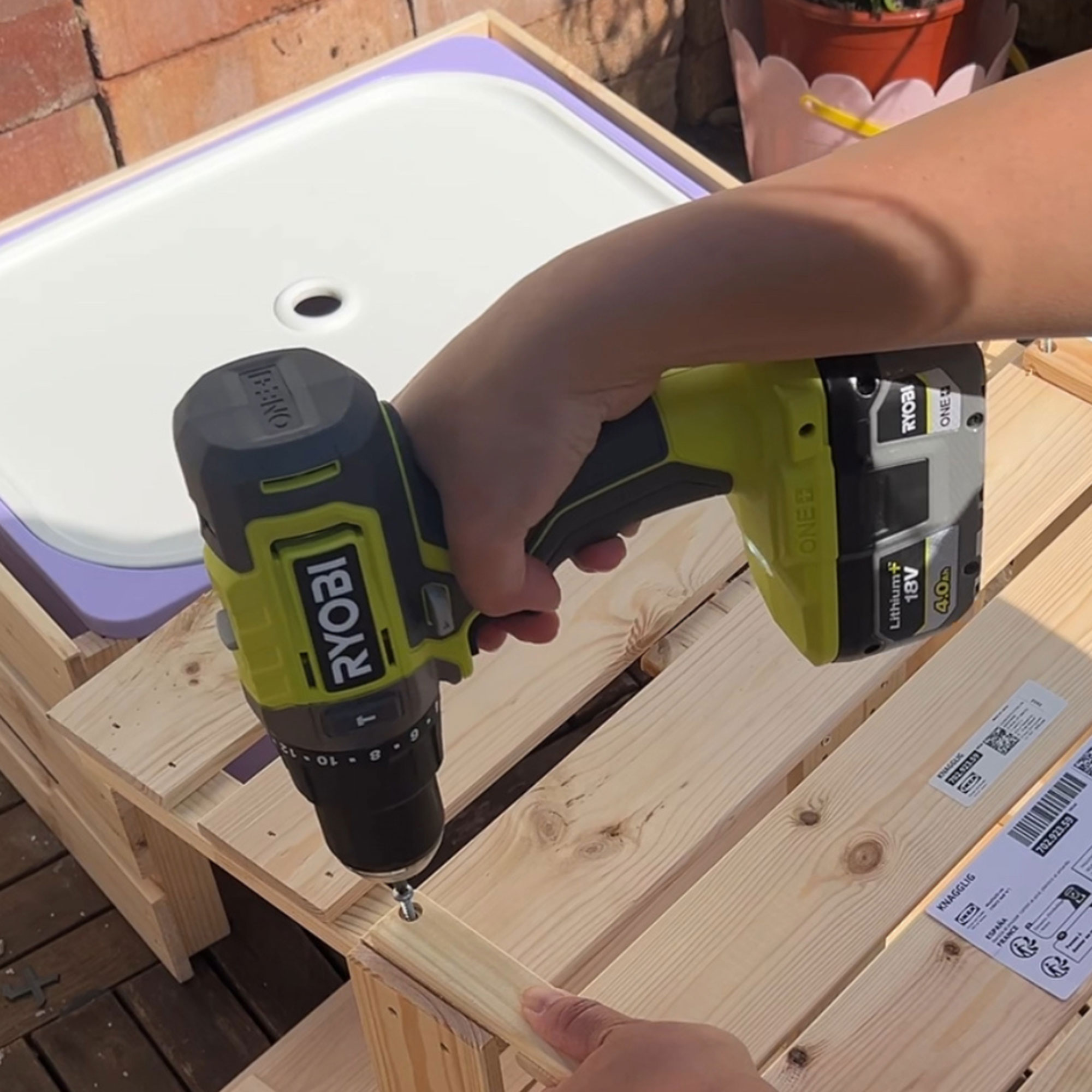 A power drill being used on an IKEA wooden item