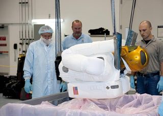 A crane is used to lift the 330-pound Robonaut 2 out of its shipping container at NASA's Kennedy Space Center in Florida. 