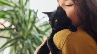 A person holding a cat