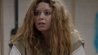 Natasha Lyonne with wild hair, looking concerned in Orange Is The New Black