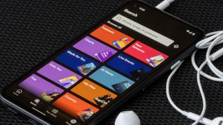 The user interface of the Spotify mobile app is seen on a Google Pixel 4a smartphone