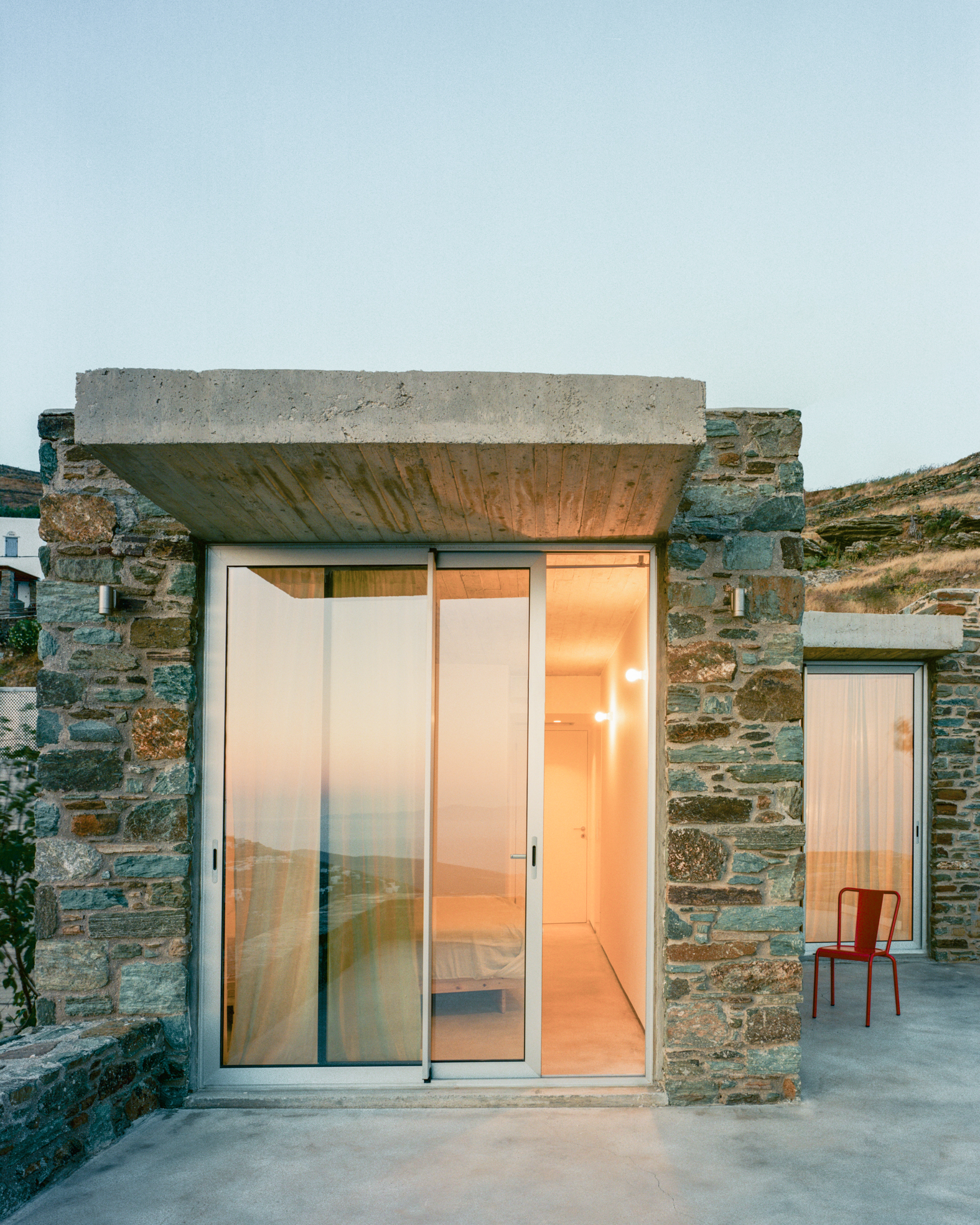 view of a Tinos house, using local vernacular such as stone walls and contemporary design