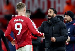 MANCHESTER, ENGLAND - DECEMBER 07: Ruben Amorim, Head Coach of Manchester United, speaks with Rasmus Hojlund of Manchester United during the Premier League match between Manchester United FC and Nottingham Forest FC at Old Trafford on December 07, 2024 in Manchester, England. (Photo by Clive Brunskill/Getty Images)