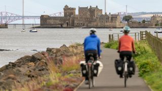 Riders on the John Muir Way with views of the Forth bridges and Blackness Castle