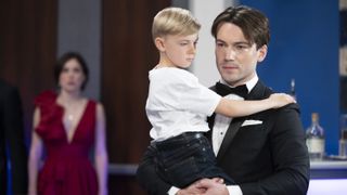 Rory Gibson as Michael carrying Viron Weaver as Wiley in General Hospital