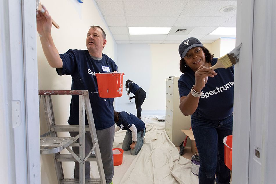 Charter&rsquo;s Paul Marchand (l.), EVP/chief human resources officer, and Rhonda Crichlow, SVP/chief diversity officer, pitch in at a Spectrum Community Assist revitalization event at the Community Action Agency of Western Connecticut&rsquo;s Lathon Wilder Community Center in Stamford, Conn.
