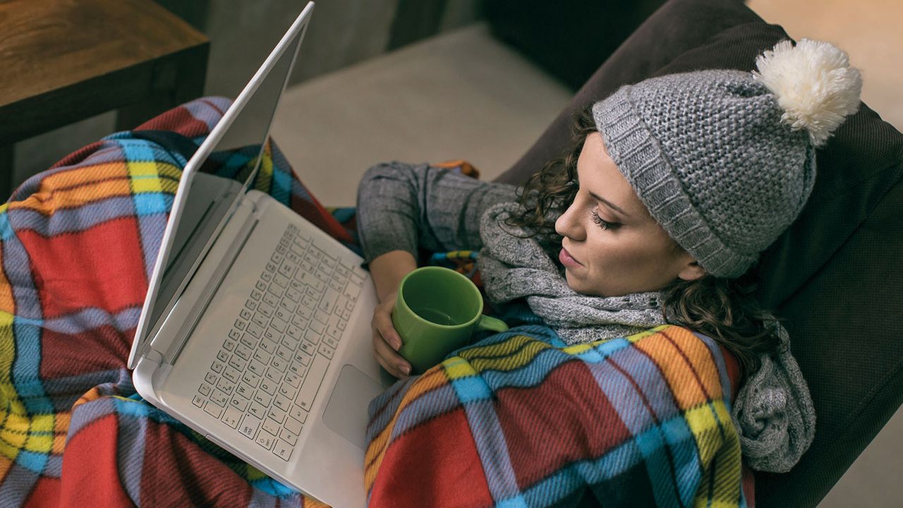 Woman on alaption wrapped in a blanket