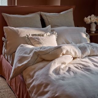 Bedroom with layer soft linen bedding in stripes and beige