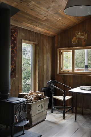 A cabin with wooden panel walls and ceiling