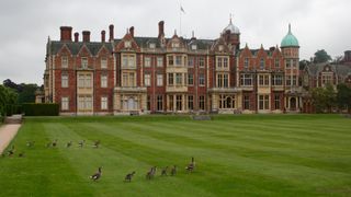 View of Sandringham House with birds walking across the lawns