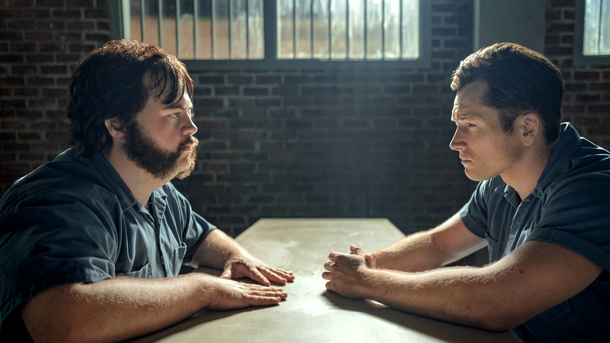 Paul Walter Hauser as Larry Hall and Taron Edgerton as Jimmy Keene in Black Bird