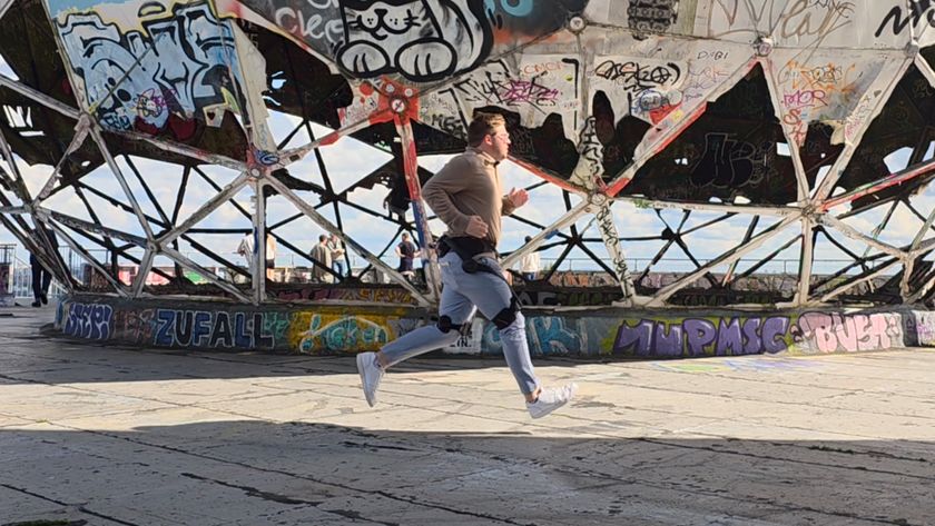 Brady running in midair while wearing Hypershell X Ultra exoskeleton.