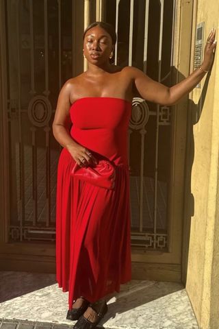 Nnenna wearing a red dress