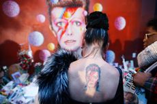 Mourners gather at a makeshift David Bowie memorial.