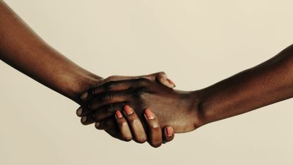 holding hands yellow background