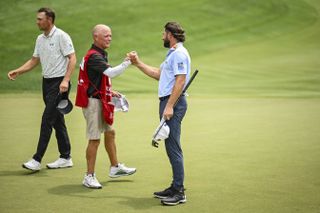 Cameron Young shakes hands with caddie after shooting 59