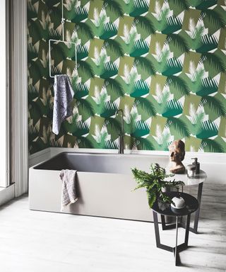 An example of modern bathroom ideas showing a botanical wallpaper next to a bath