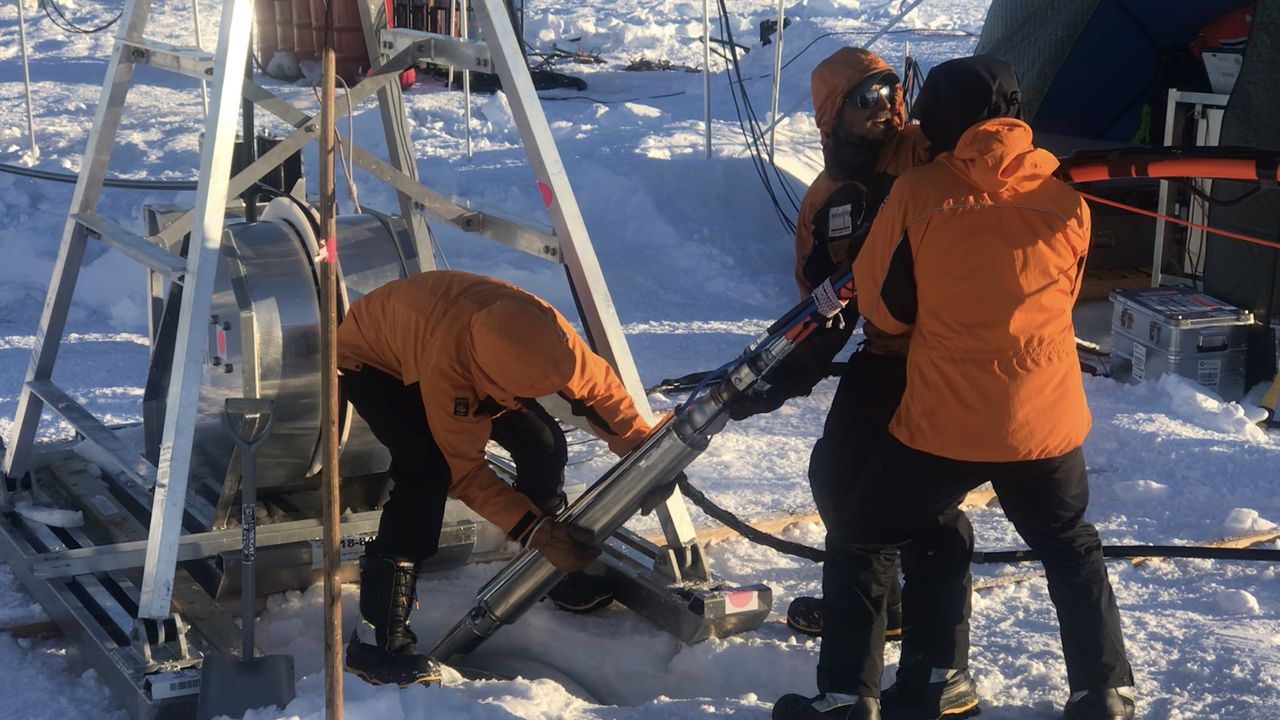 British Antarctic Survey researchers lower the hot water drill as they begin drilling through Thwaites Glacier so that Icefin would be able to reach the glacier's grounding zone.