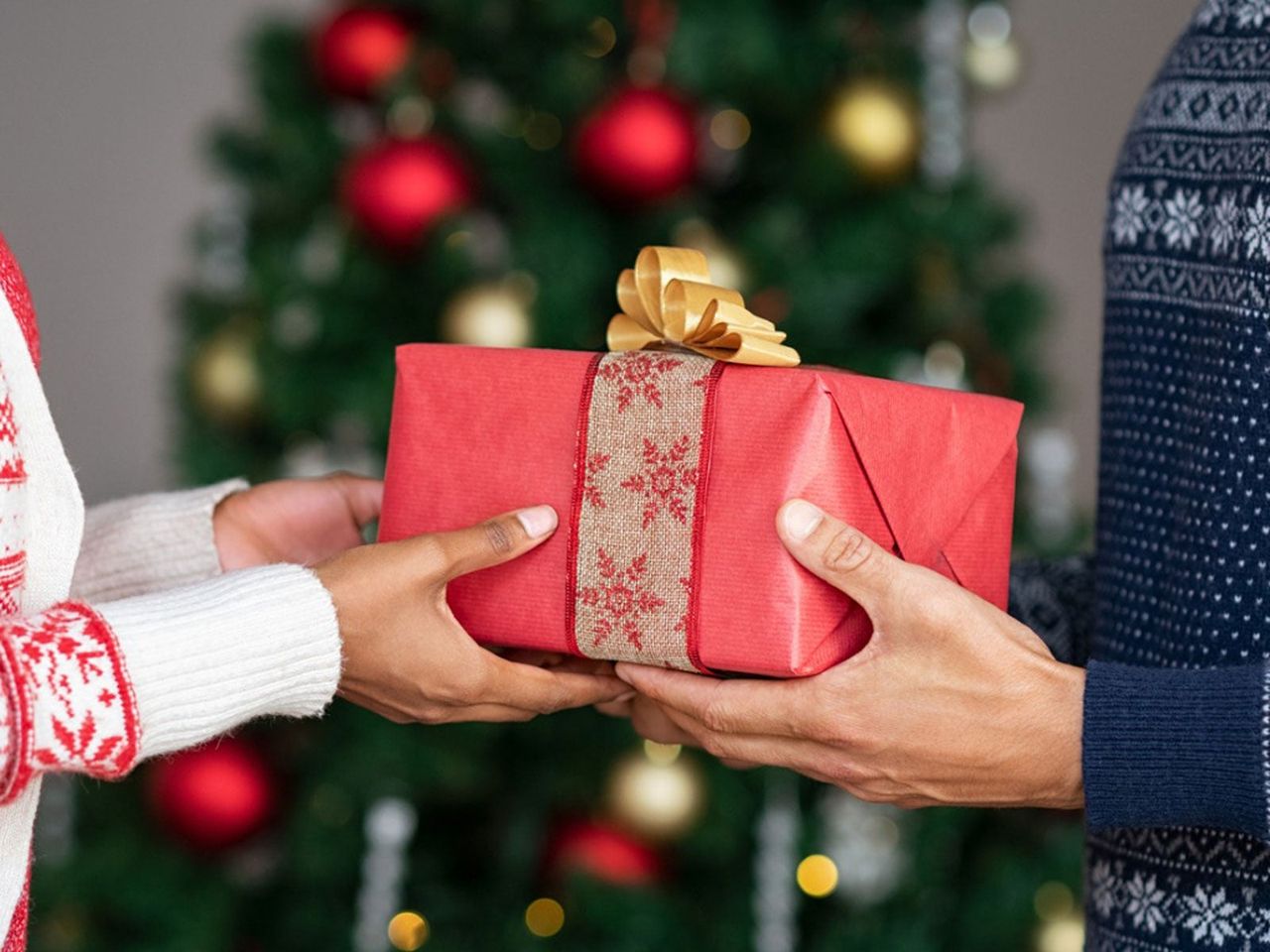 People Exchanging Red Christmas Gift