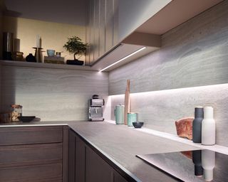 An LED kitchen lighting plan with grey cabinetry and backsplash.