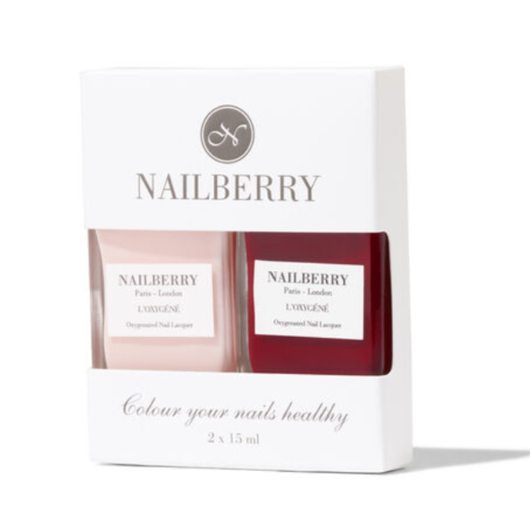 A product shot of the Nailberry Classic Chic nail polish set, which features a sheer pink nail polish and a burgundy nail polish, on a white background