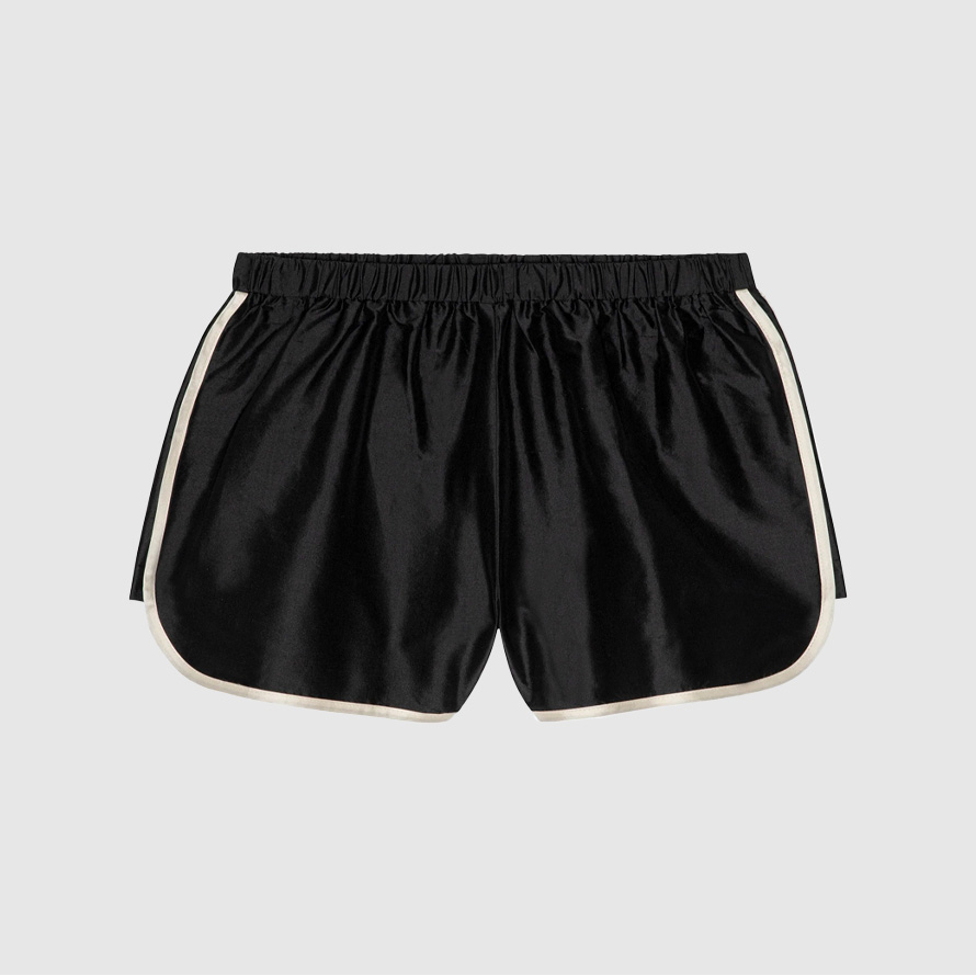 Black taffeta track shorts with white side stripes.