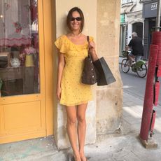 Devon Lee Carlson in a yellow polka dot dress
