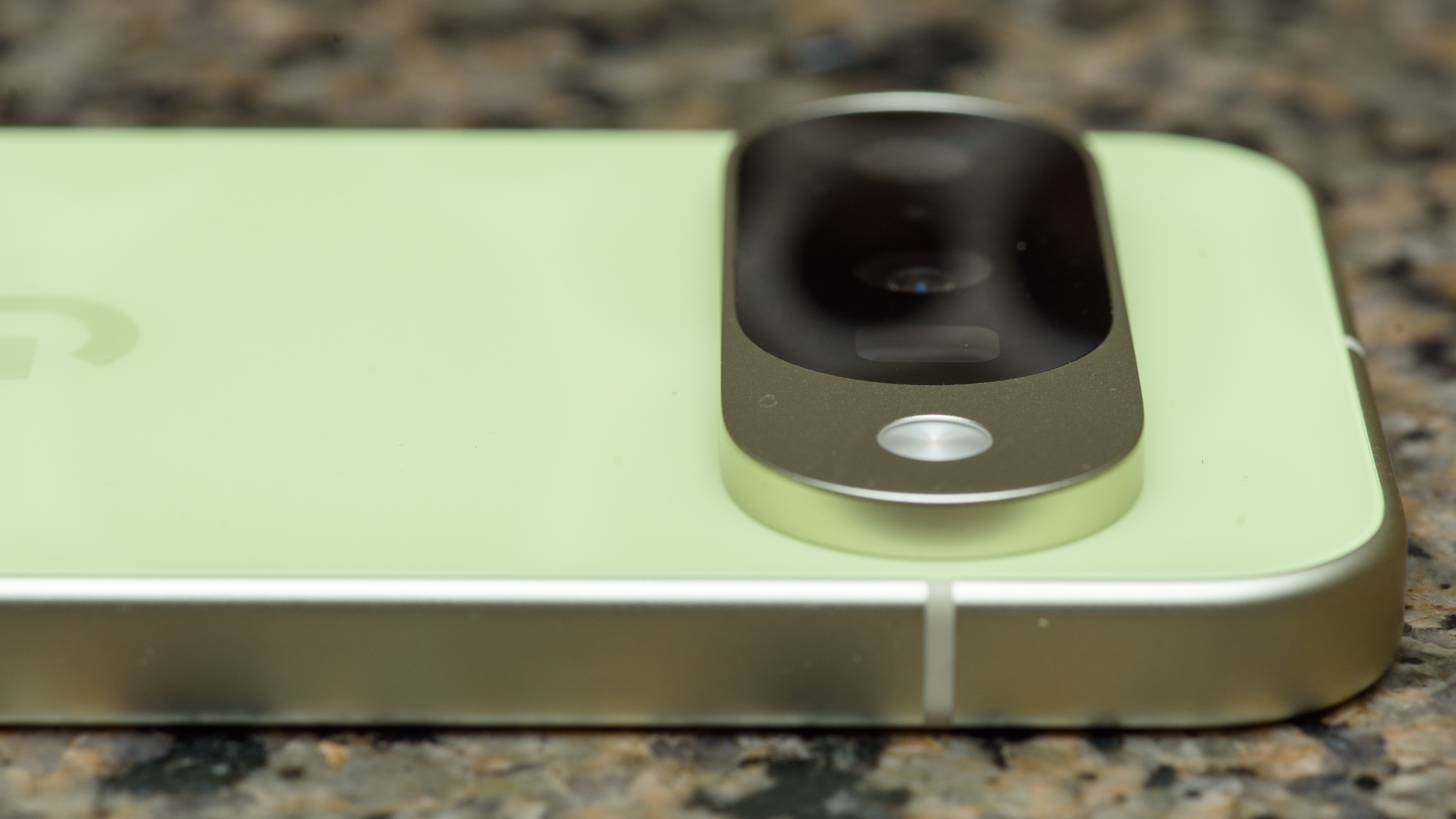 Google Pixel 10 in Lemongrass against a bubbly backsplash