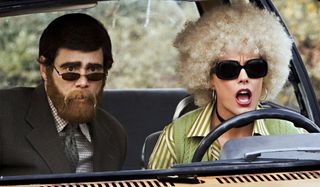 Jim Carrey and Tea Leoni scope out a bank in disguise in Fun with Dick and Jane.