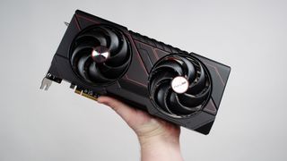 A masculine hand holding an AMD Radeon RX 9070