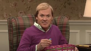 Michael Keaton as a bizarre version of himself holding an Easter basket on SNL